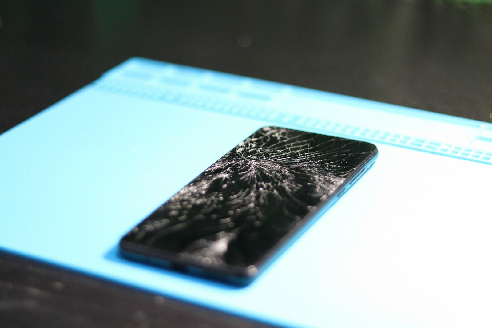 Close-up of a cracked smartphone screen before repair