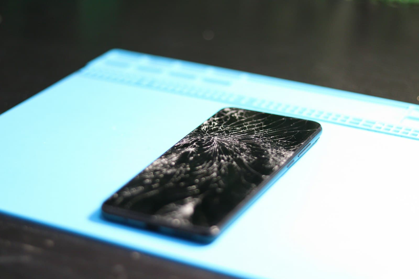 Cracked smartphone screen closeup before repair