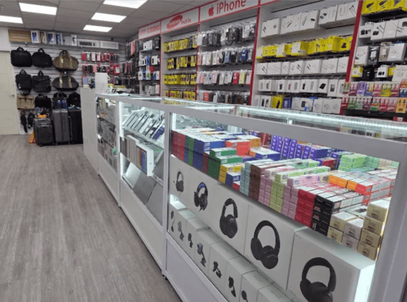 Greenwich Gadgets interior — accessory wall, headphones and travel bags